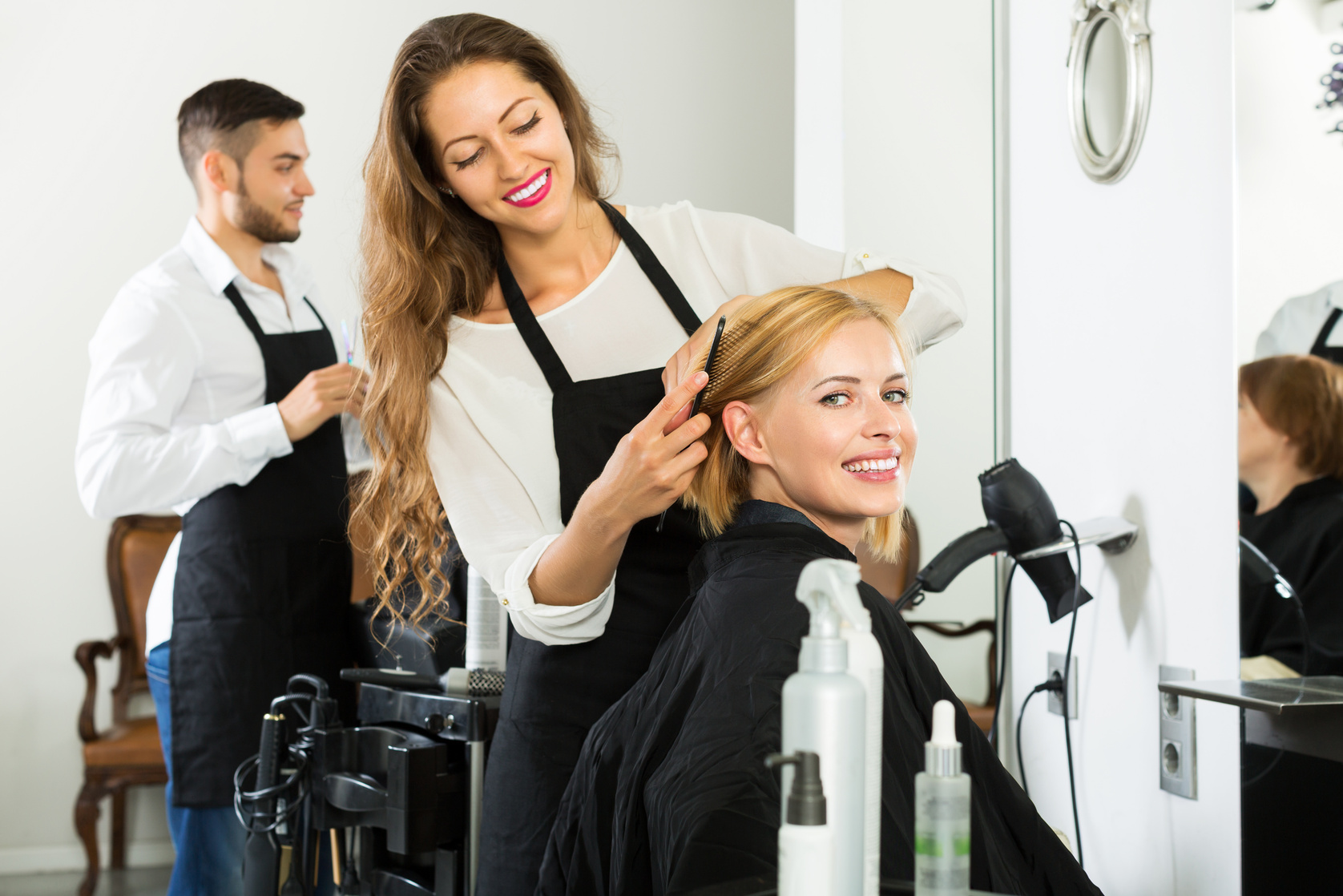 Hairdresser doing hairstyle